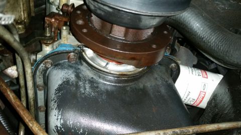 1991 Ford F-250 - Close-up view of the engine oil pan and filter on a 1991 Ford F-250, showing mechanical components.