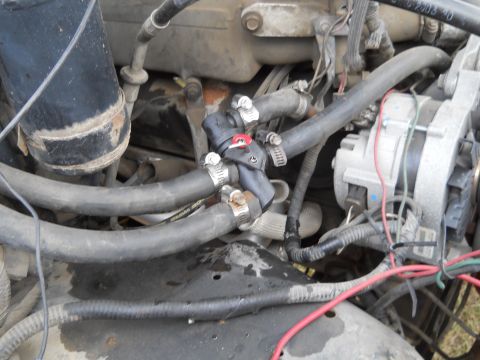 1992 Ford Bronco - Close-up view of engine components including hoses, wiring, and the alternator.