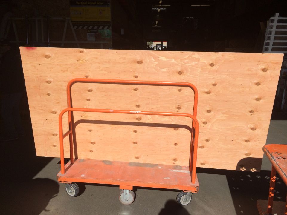 Plywood sheet on orange cart