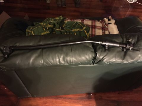1994 Ford Bronco - A tie rod assembly is displayed on a leather couch, with a cat in the background.