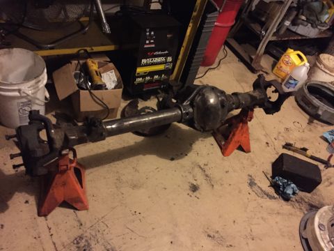 1994 Ford Bronco - Rear axle assembly for a Ford Bronco, supported by jack stands in a workshop environment.