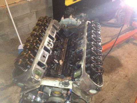 1994 Ford Bronco - Close-up view of a V8 engine block with the valve covers removed, revealing the internal components.