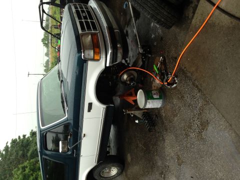1994 Ford Bronco - Front end of a 1994 Ford Bronco undergoing repairs, with suspension components visible.
