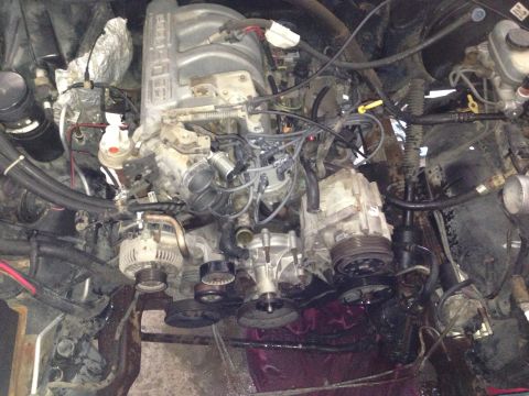 1994 Ford Bronco - A close-up view of a vehicle's engine bay, showing complex mechanical parts and wiring.