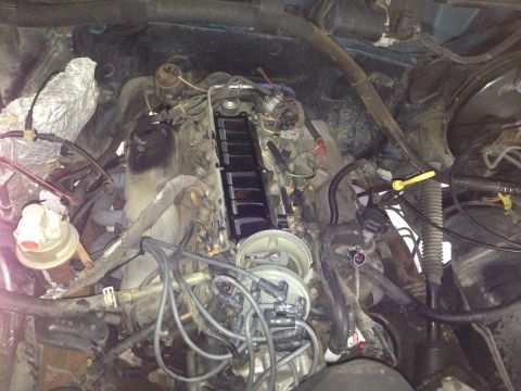 1994 Ford Bronco - Close-up view of a vehicle's engine bay, showing various components and wiring.