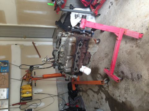 1994 Ford Bronco - An engine is mounted on an engine stand, ready for work or transport.