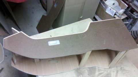 1982 Ford Bronco - A custom-cut wood panel is shown, possibly for a vehicle's interior, resting on wooden supports.
