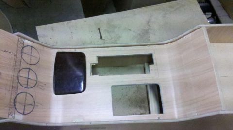 1982 Ford Bronco - Unfinished wooden dashboard console shows cutouts for components and marked circles for speakers during a rebuild.