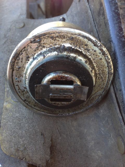 1979 Ford Bronco - Close-up of a heavily used ignition lock cylinder, showing wear and grime.