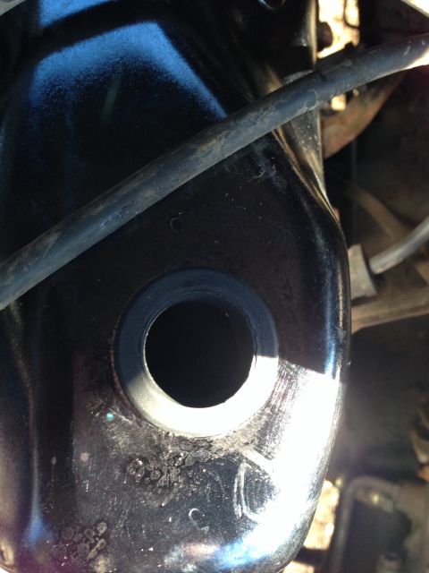 1979 Ford Bronco - Black painted metal part with a circular opening and a rubber grommet is visible.
