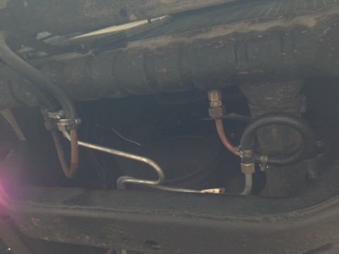 1979 Ford Bronco - Close-up view of the interior of a vehicle, focusing on the seating area and exposed wiring.