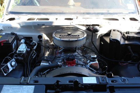 1982 Ford Bronco - The engine bay of a classic vehicle, likely a 1982 Ford Bronco, is shown with a chrome air cleaner, red distributor cap, and various hoses…