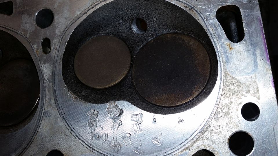 Close-up of a damaged Ford Bronco engine cylinder head with two valves.