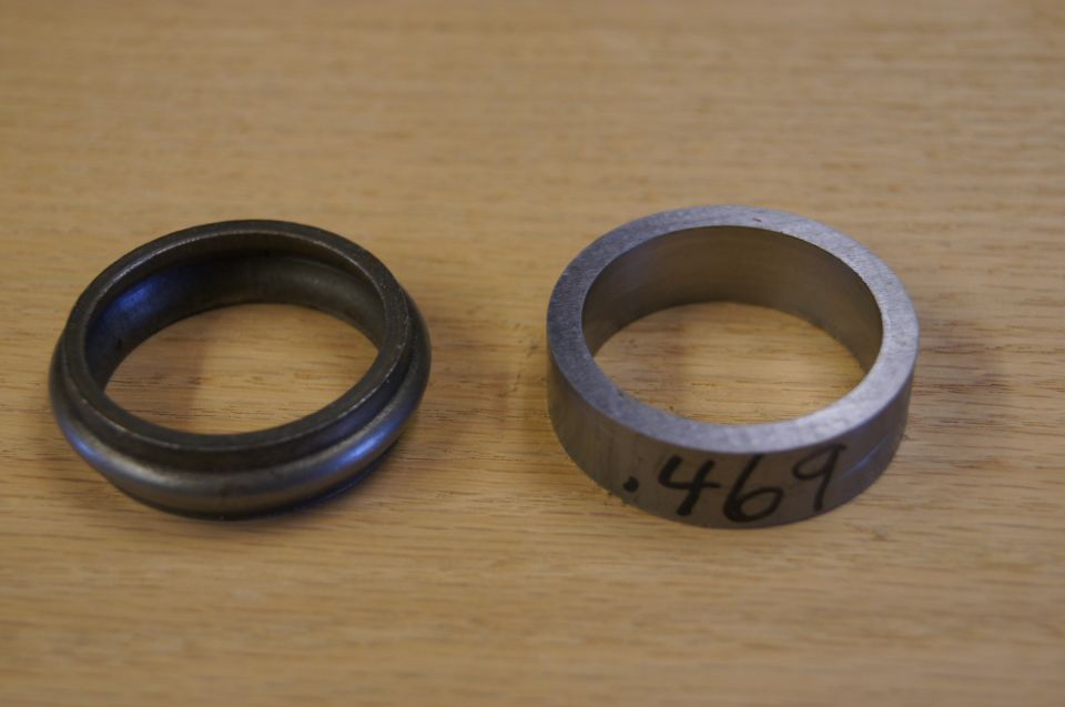 Two metal spacer rings on wood table; right ring marked .469 in black marker