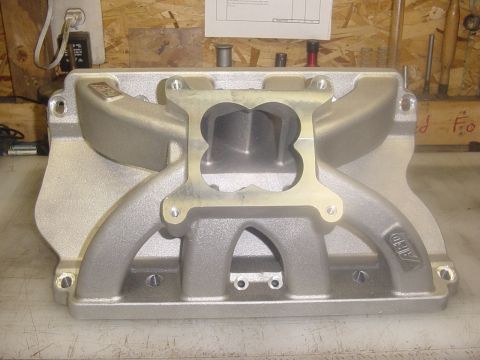1972 Ford Ranchero - A silver aluminum intake manifold with a dual-plane design is shown from a front-facing angle. The manifold has "ARD" branding visible on i…