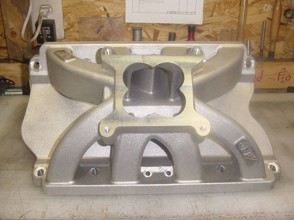 Silver aluminum dual-plane intake manifold with ARD branding.