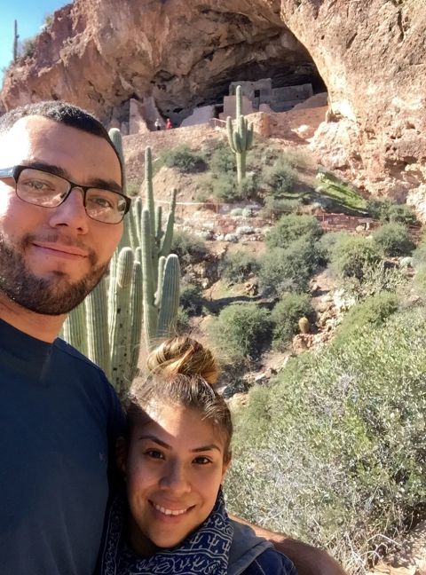 1996 Ford Bronco - A man and a woman take a selfie in front of a cliff dwelling with saguaro cacti.