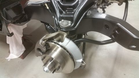 1970 Pontiac Trans Am - Close-up view of a vehicle's front suspension and braking system during restoration.