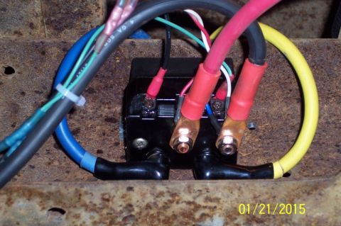 1973 Ford F-250 - Close-up view of a black electrical relay box with several heavy gauge wires connected to it. The wires are red, black, blue, and yellow, w…