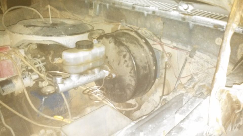 1979 Ford Bronco engine bay, showing brake master cylinder, brake booster, and air cleaner.