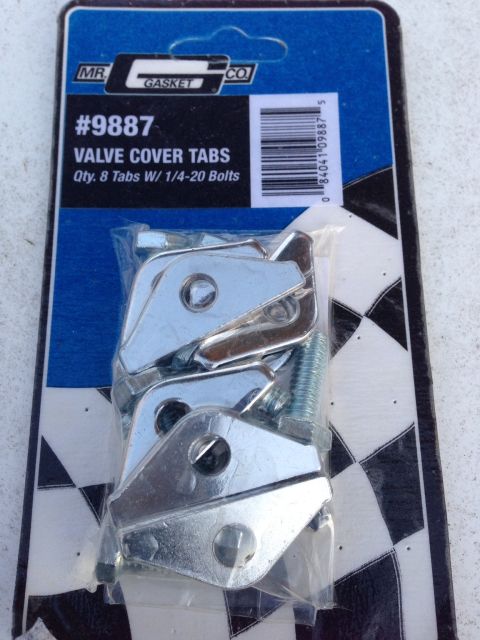 1979 Ford Bronco - A package of Mr. Gasket Valve Cover Tabs, part number 9887, containing 8 tabs and 1/4-20 bolts. The packaging shows a checkered pattern and…