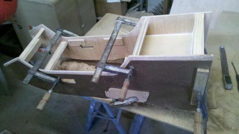 1982 Ford Bronco - A wooden center console is being assembled and held together with several clamps in a workshop.