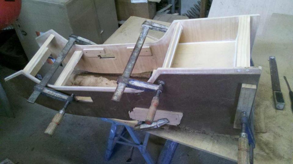 Wooden center console under construction, held by clamps
