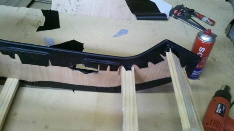 1982 Ford Bronco - Car interior trim piece undergoing repair or modification with tools and adhesive spray.
