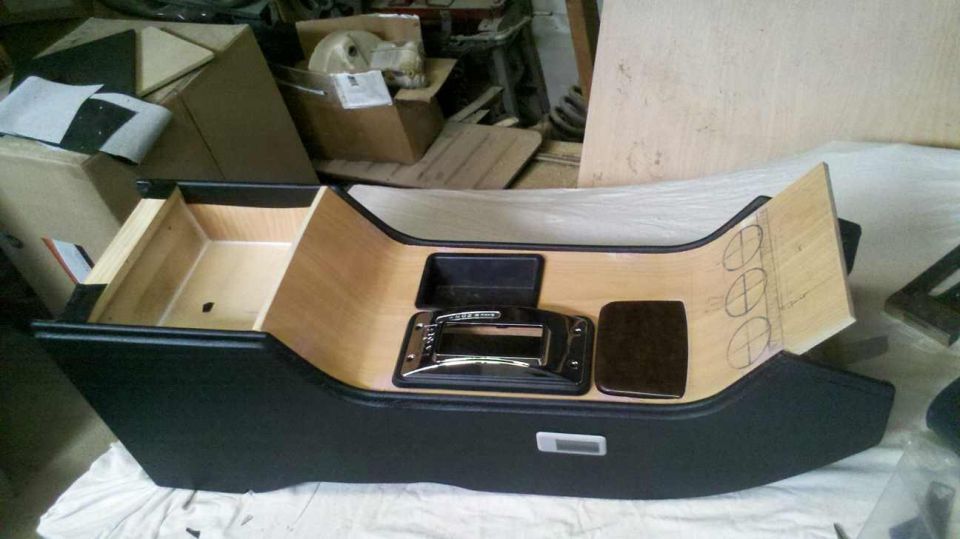 Center console with gear shifter and wood trim, marked for gauges