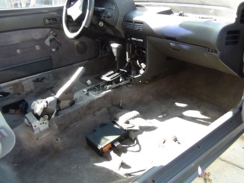 1991 Ford Probe - The interior of a 1991 Ford Probe shows significant disassembly and exposed components.