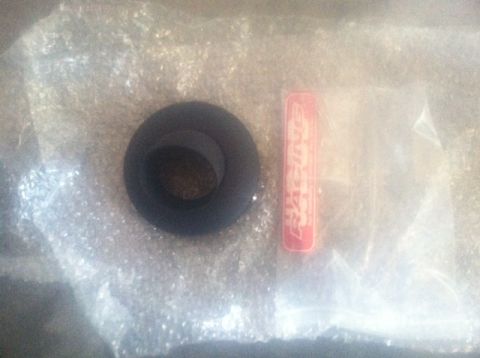2005 Honda TRX 450 R - A black rubber grommet and a red "RACING" sticker are shown in packaging.