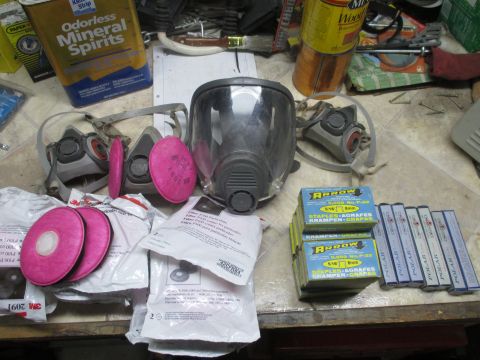 2004 Aston Martin Virage - Various safety and workshop supplies are laid out on a cluttered workbench.