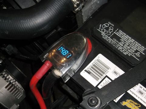 1979 Ford Ranchero - Digital voltage meter connected to a car battery, displaying 19.88 volts.