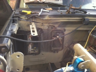 1995 Ford Bronco - The interior of a vehicle is shown with parts of the dashboard removed for repair or maintenance.