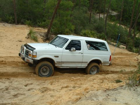 1995 Ford Bronco - This 1995 Ford Bronco navigates a challenging sandy terrain, its off-road capabilities.