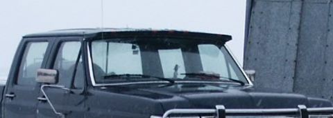 1990 Ford Bronco - This 1990 Ford Bronco truck is seen from a 3/4 front angle, with a chrome bumper and a sun visor.