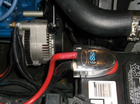 1979 Ford Ranchero - A digital voltage meter displays 18.8V connected to a car battery and alternator.