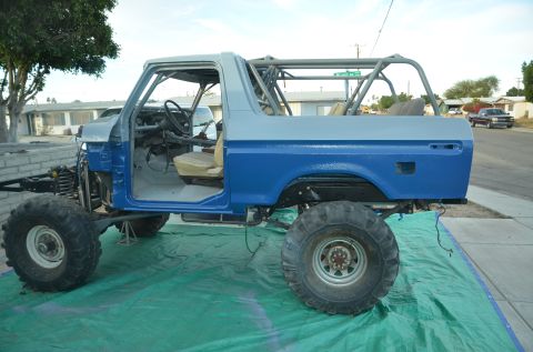 1979 Ford Bronco - This vehicle is undergoing modifications, with its front end removed and a roll cage installed.