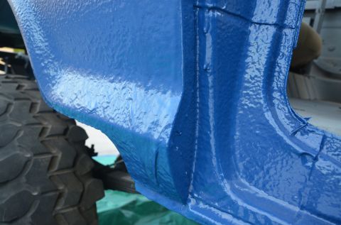 1979 Ford Bronco - Close-up of a blue painted vehicle frame section and tire. Supermotors.net logo is visible.