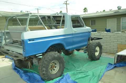 1979 Ford Bronco - Customized 1978 Ford Bronco undergoing modifications with a prominent roll cage and lifted suspension.