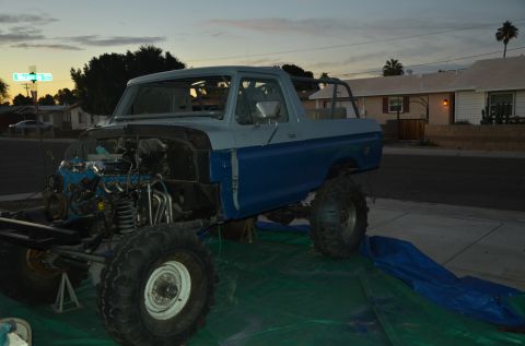 1979 Ford Bronco - This Ford Bronco is undergoing repairs, with its engine compartment open and the vehicle elevated on stands.