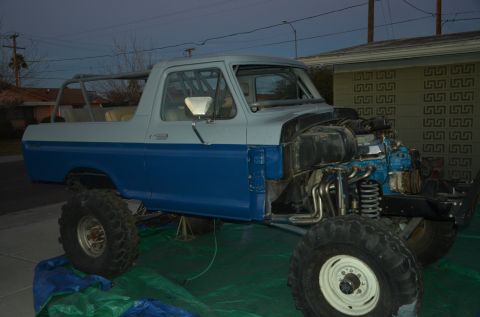 1979 Ford Bronco - Ford Bronco undergoing modification, engine and front suspension are exposed.