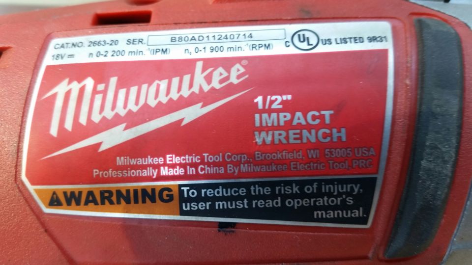 Milwaukee 1/2" impact wrench label with model and warning info