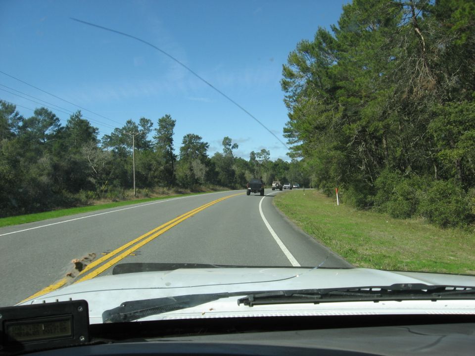 Black SUV on highway, seen from inside another vehicle
