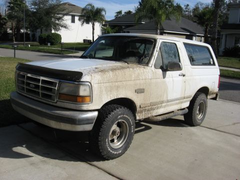 1994 Ford Bronco - This 1994 Ford Bronco is heavily soiled with mud, suggesting recent off-road use.