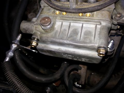 1981 Ford Bronco - Close-up of a Holley carburetor, showing part details and connected hoses.