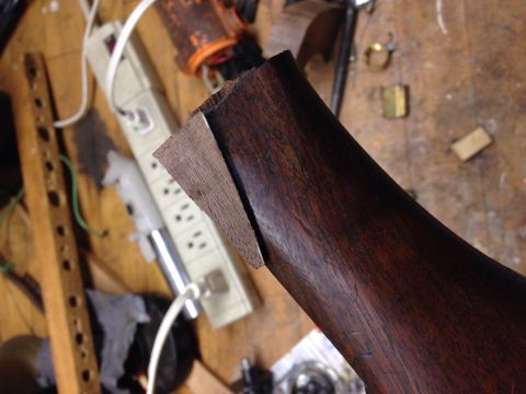 1996 Ford Bronco - A close-up view of a wooden part with a contrasting wood inlay, showing the grain and texture.