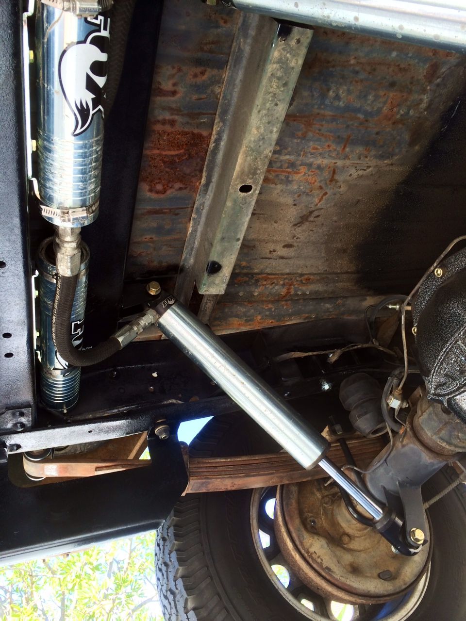 Fox shock absorber and steering stabilizer mounted on vehicle's undercarriage