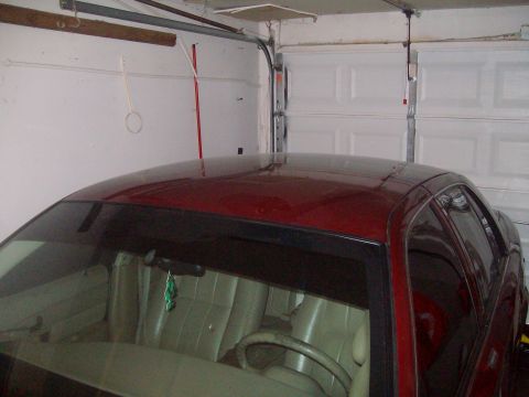 2004 Ford Crown Victoria - Interior view of a red sedan parked inside a garage.