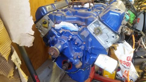 1979 Ford F-150 - A blue V8 engine, likely a Ford, is shown with its oil filter and mounted on a stand.